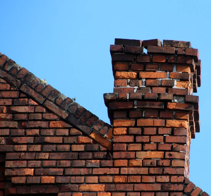Damaged chimney on an Berkley home showing cracks and missing mortar